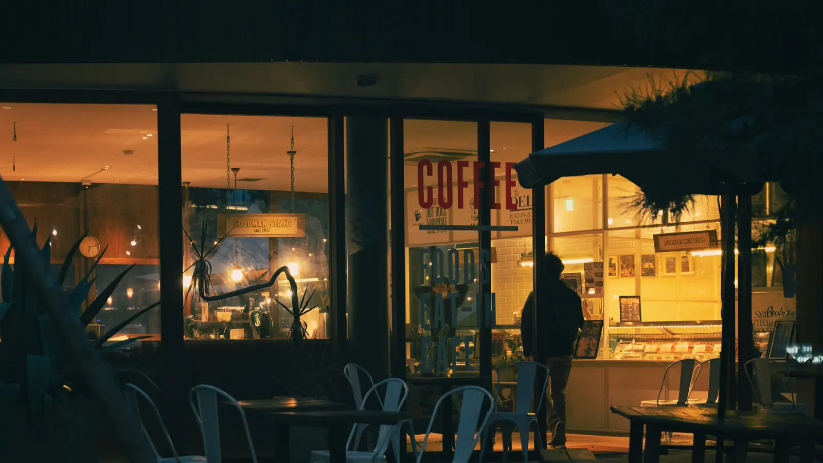 A shop front lit up in the early evening.